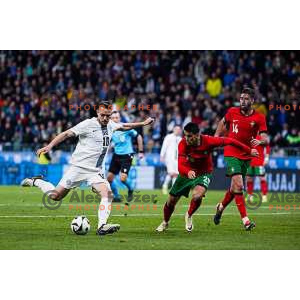 Timi Max Elsnik of Slovenia vs Joao Cancelo of Portugal in action during Friendly football match between Slovenia and Portugal in Stadium Stozice, Slovenia on March 26, 2024. Photo: Grega Valancic