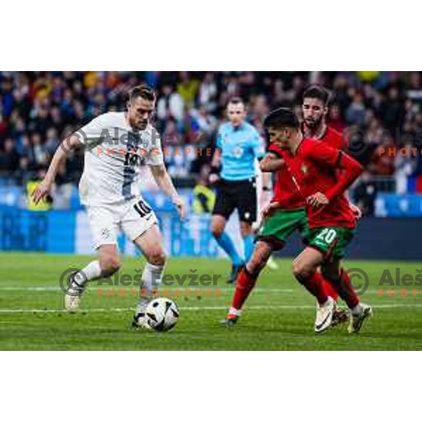 Timi Max Elsnik of Slovenia vs Joao Cancelo of Portugal in action during Friendly football match between Slovenia and Portugal in Stadium Stozice, Slovenia on March 26, 2024. Photo: Grega Valancic