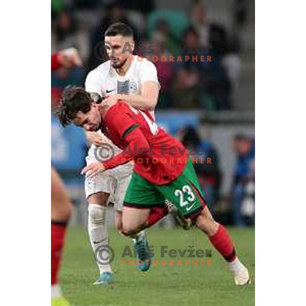 Petar Stojanovic and Vitinha in action during a friendly football match between Slovenia and Portugal in Ljubljana, Slovenia on March 26, 2024