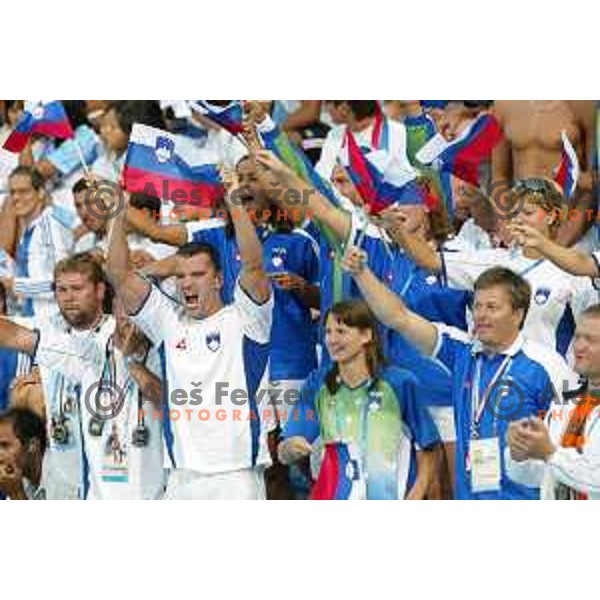 Peter Mankoc, Sara Isakovic and swimmers of Slovenia cheering at Athens 2004 Summer Olympic games in Athens, Greece on August 18, 2004