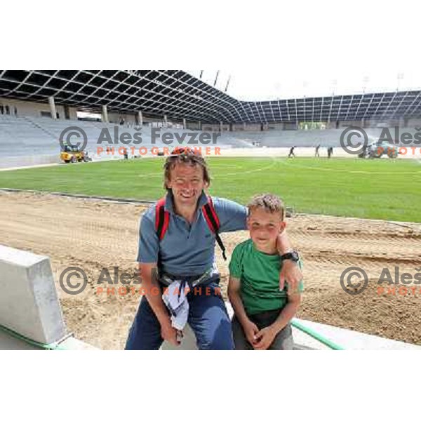 Gregor Zidan with his son Tim watching new turf on the pitch at Stozice football stadium in construction, Ljubljana, Slovenia 1.5.2010 