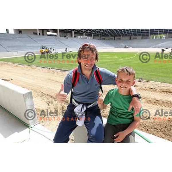 Gregor Zidan with his son Tim watching new turf on the pitch at Stozice football stadium in construction, Ljubljana, Slovenia 1.5.2010 