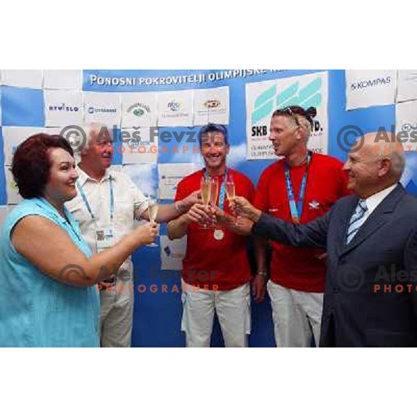 Milos Jansa, Iztok Cop and Luka Spik of Slovenia, silver medalists in rowing at Summer Olympic Games in Athens, Greece , August 2004 during reception for sponsors and press in Slovenia house receive congratulations from Janez Kocijancic 