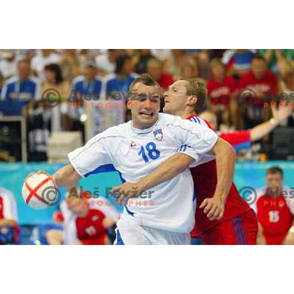Uros Zorman of Slovenia and Edi Koksharov of Russia in action during Handball tournament at Summer Olympic Games Athens 2004, Greece. Slovenia played with Russia on August 13, 2004 